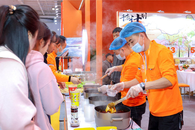 3月兰州餐饮加盟连锁展会现场观众试吃特色小吃